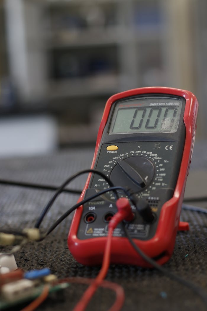 Services Professional multimeter with wires that combining functions of voltmeter ammeter ohmmeter placed on floor